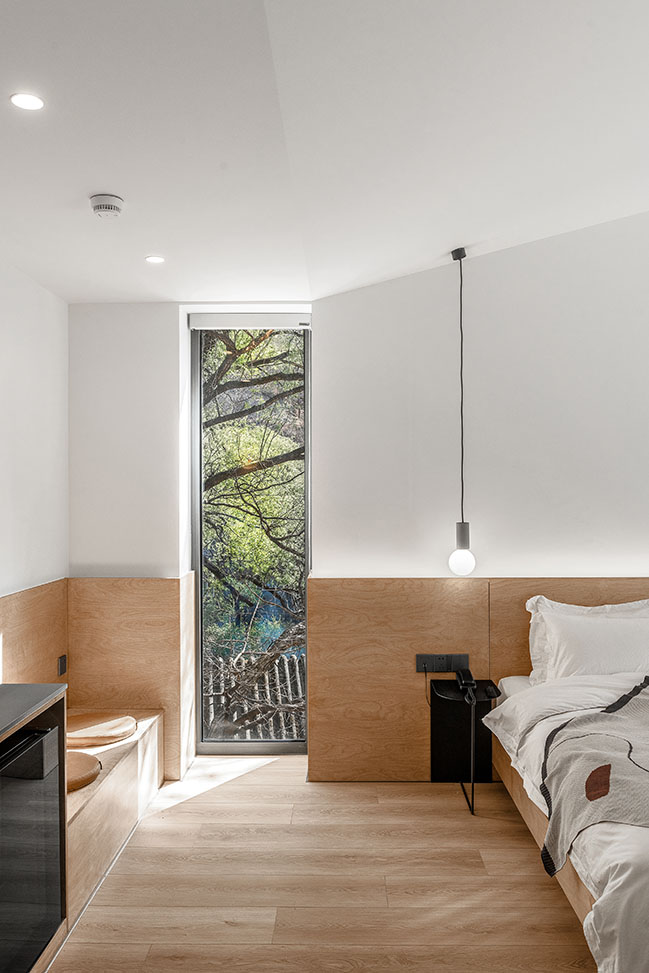 Fon Studio renovated a farmhouse into a modern hotel in a serene valley