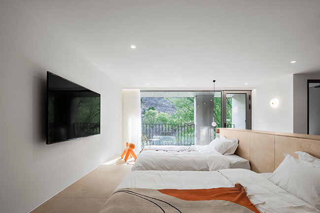 Fon Studio renovated a farmhouse into a modern hotel in a serene valley