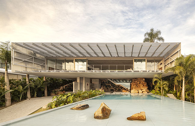 Ponte House by TETRO | Harmonious Coastal Residence on Cacupé Sea with Bridge and Stone Accents