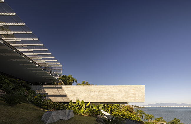 Ponte House by TETRO | Harmonious Coastal Residence on Cacupé Sea with Bridge and Stone Accents