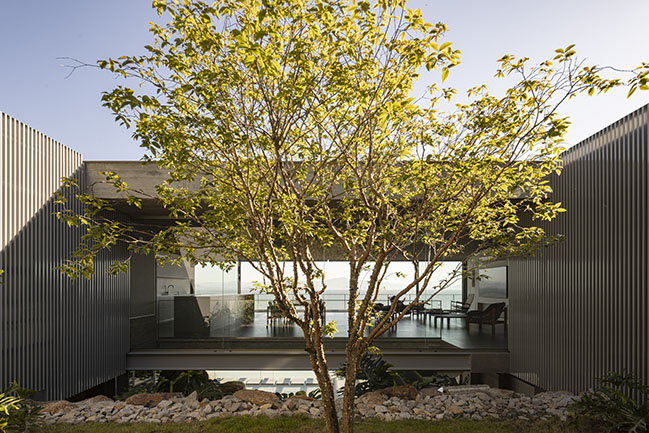 Ponte House by TETRO | Harmonious Coastal Residence on Cacupé Sea with Bridge and Stone Accents