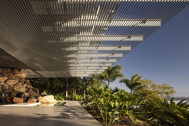 Ponte House by TETRO | Harmonious Coastal Residence on Cacupé Sea with Bridge and Stone Accents